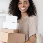 Packing For Barcelona - A Woman Holding Cardboard Boxes