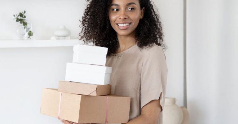 Packing For Barcelona - A Woman Holding Cardboard Boxes