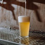 Craft Beer Barcelona - Beer Pouring Into Clear Drinking Glass on Metal Surface