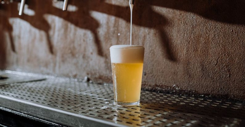 Craft Beer Barcelona - Beer Pouring Into Clear Drinking Glass on Metal Surface