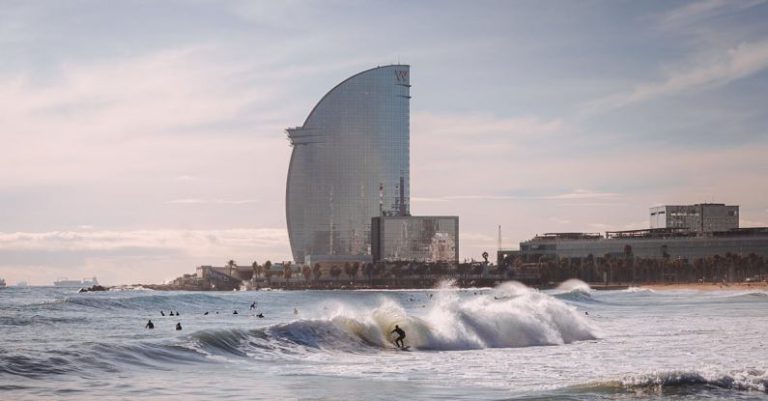 Barcelona Beach - Person Surfing With High-rise Building Background