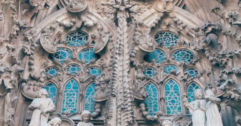 Historic Hotels Barcelona - From below of aged stone Sagrada Familia church with carved elements and sculptures in Gothic style in Barcelona