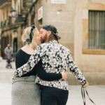 Romantic Barcelona - A Couple Kissing while Walking on the Street