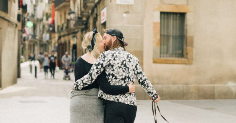 Romantic Barcelona - A Couple Kissing while Walking on the Street