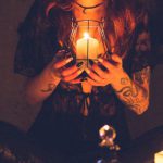 Gothic Night Barcelona - Spooky witch among candles during ritual
