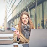 Coffee Shops Barcelona - Woman in Brown Coat Holding a Bank Card