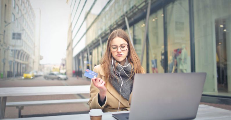 Coffee Shops Barcelona - Woman in Brown Coat Holding a Bank Card
