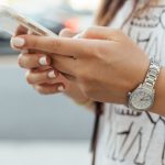 Mobile - woman holding iPhone during daytime