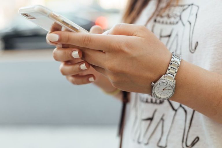 Mobile - woman holding iPhone during daytime