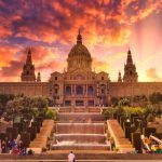 Barcelona - people sitting on bench near building during sunset
