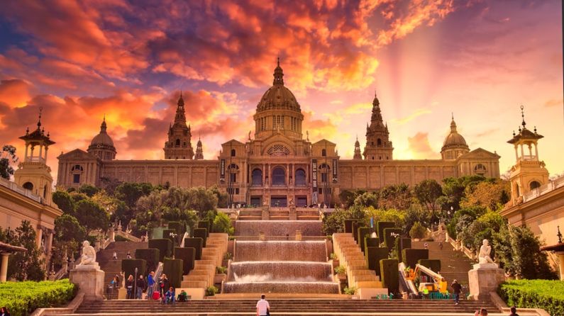 Barcelona - people sitting on bench near building during sunset