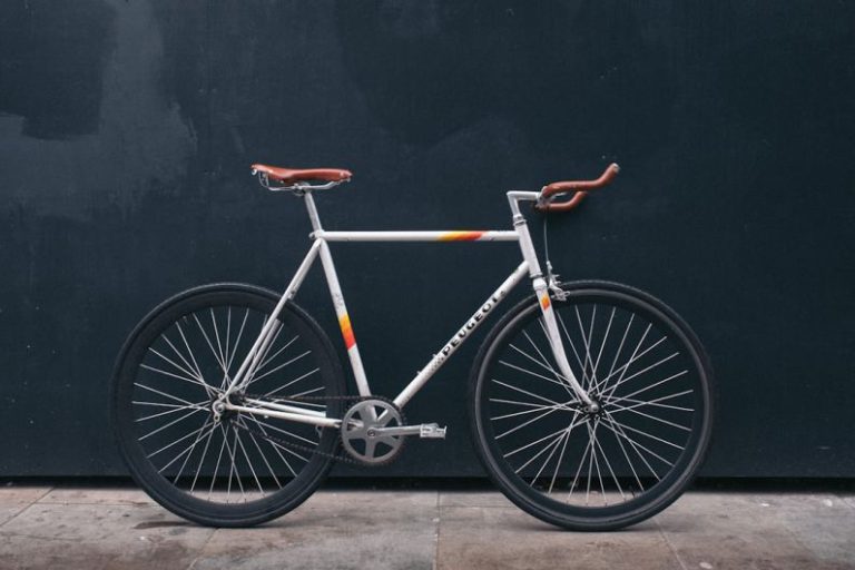 Bike - gray fixie bike leaning on black wall