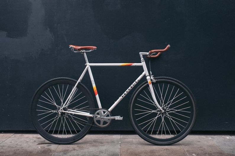 Bike - gray fixie bike leaning on black wall