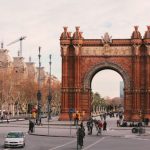 Barcelona - people walking on sidewalk near brown concrete building during daytime