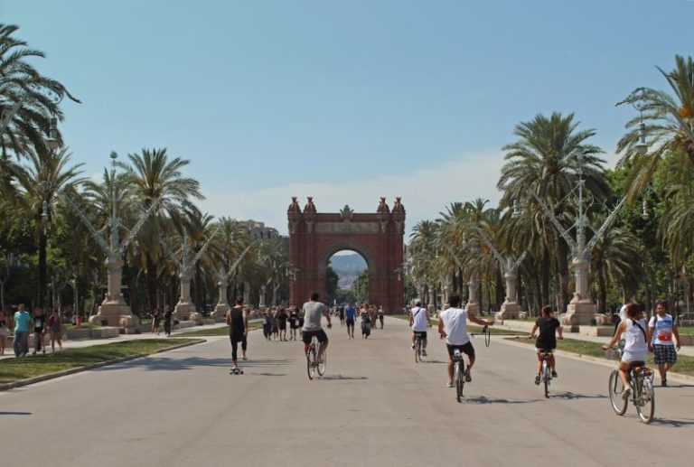 Barcelona - people running and riding bicycles on cement