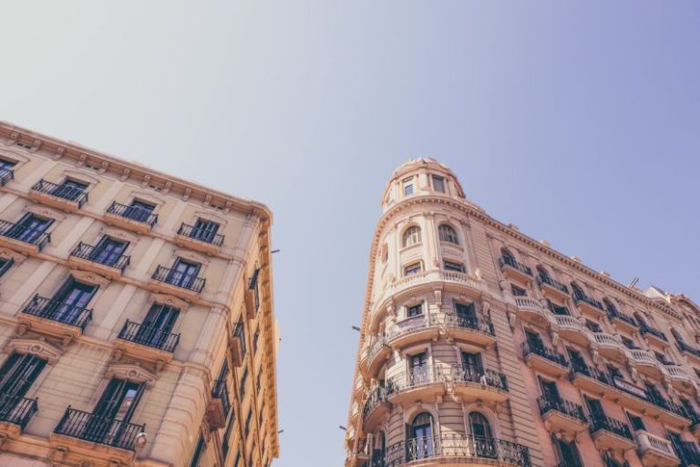 Barcelona - worm's eyeview photo of beige high-rise buildings