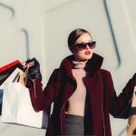 Shopping - photo of woman holding white and black paper bags