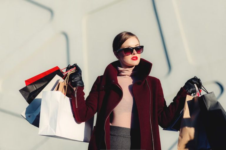 Shopping - photo of woman holding white and black paper bags