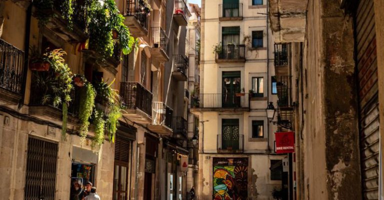 La Rambla - Black Motorcycle Beside of Brown Painted Buildings