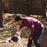 Pet Outdoor - man playing with dog