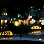Taxi - shallow focus photography of Taxi signage