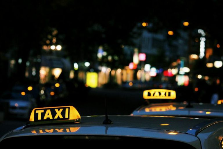 Taxi - shallow focus photography of Taxi signage