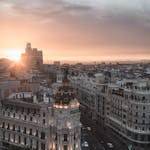 Stunning view of Madrid cityscape with sunset over the Metropolis Building.